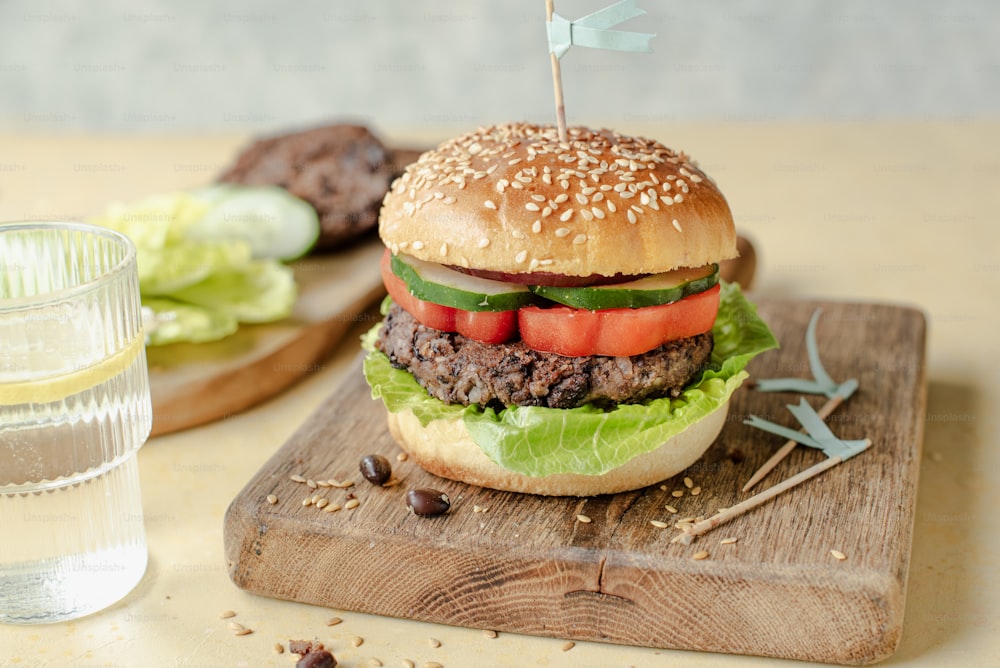a hamburger sitting on top of a wooden cutting board