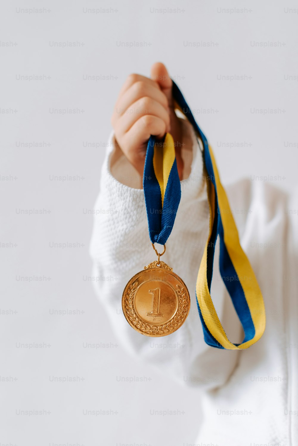 a person holding a medal in their hands