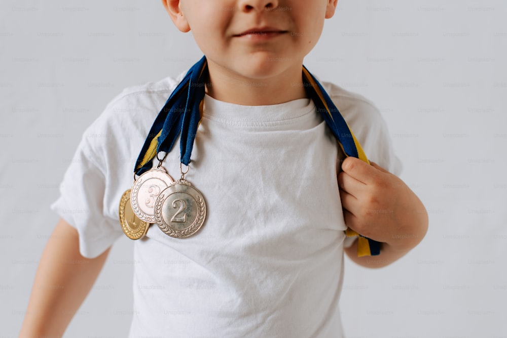 a young boy wearing a medal around his neck