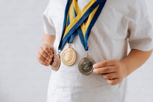 a person holding two medals in their hands