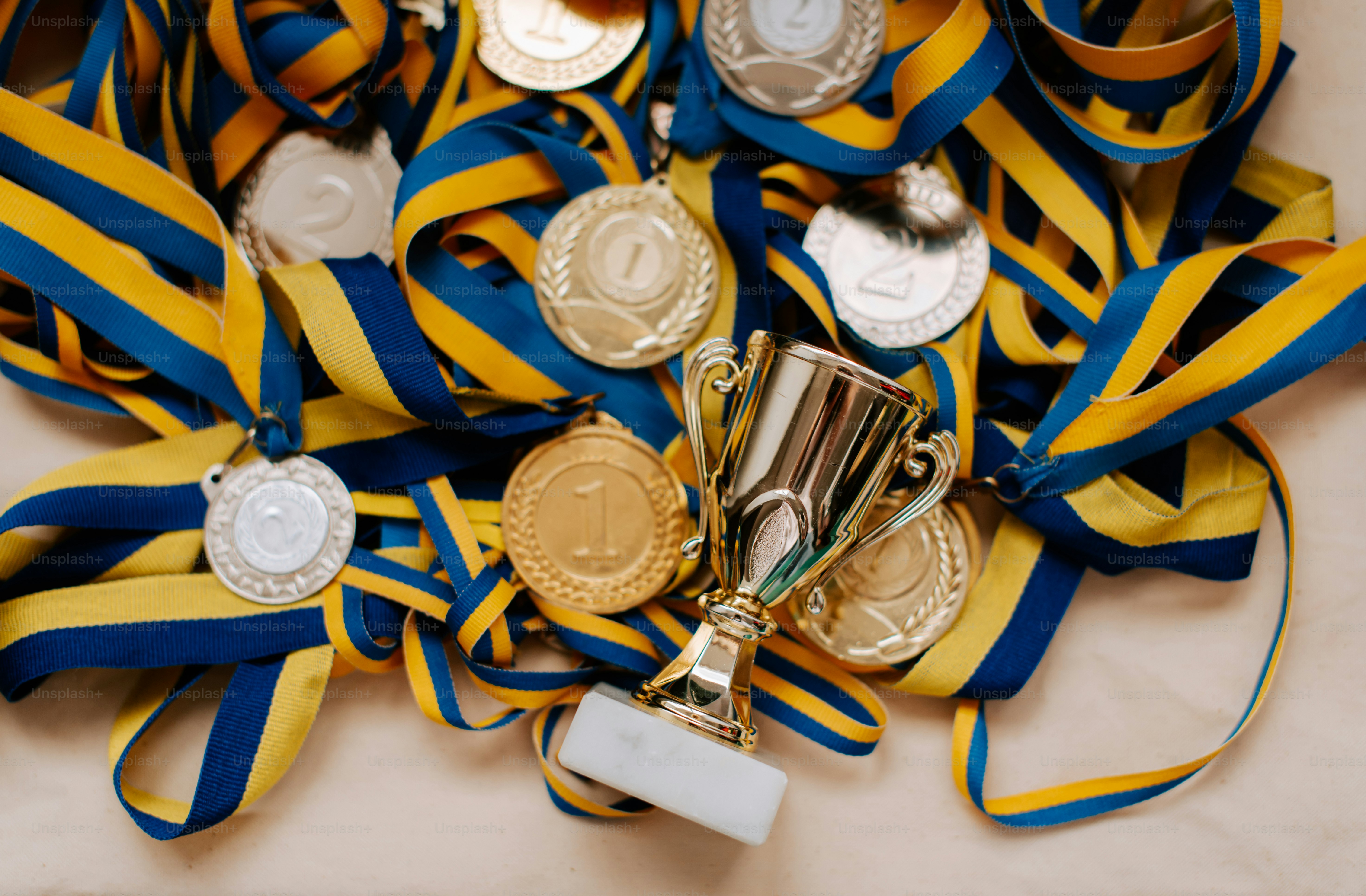 a bunch of medals and a trophy on a table