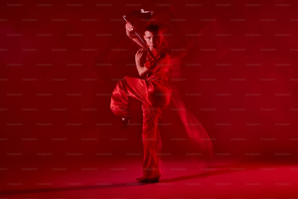 a woman in a red outfit is dancing
