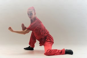 a woman in a red outfit is doing a yoga pose