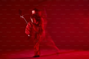 a man in a red kimono standing in a dark room