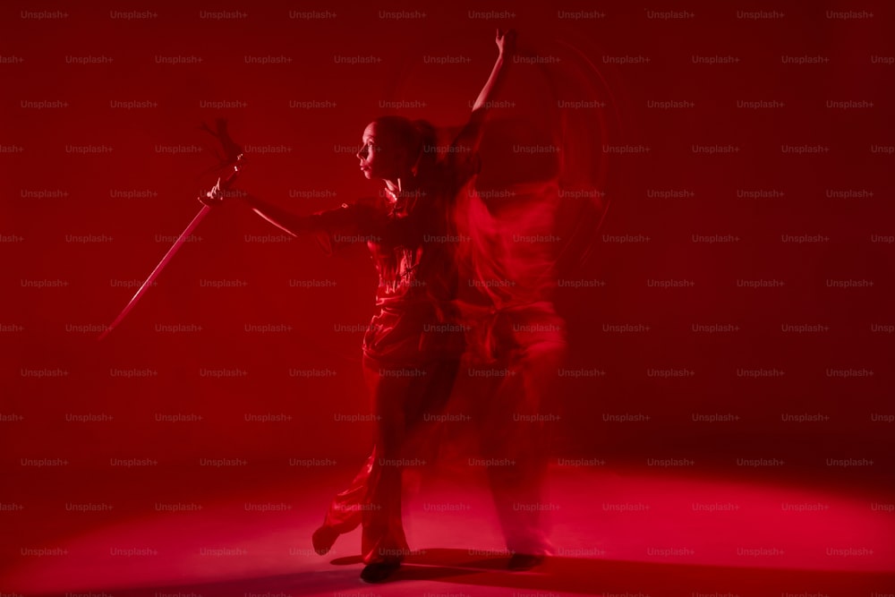 a man with a sword in a red light