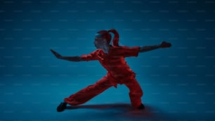 a woman in a red jumpsuit is dancing