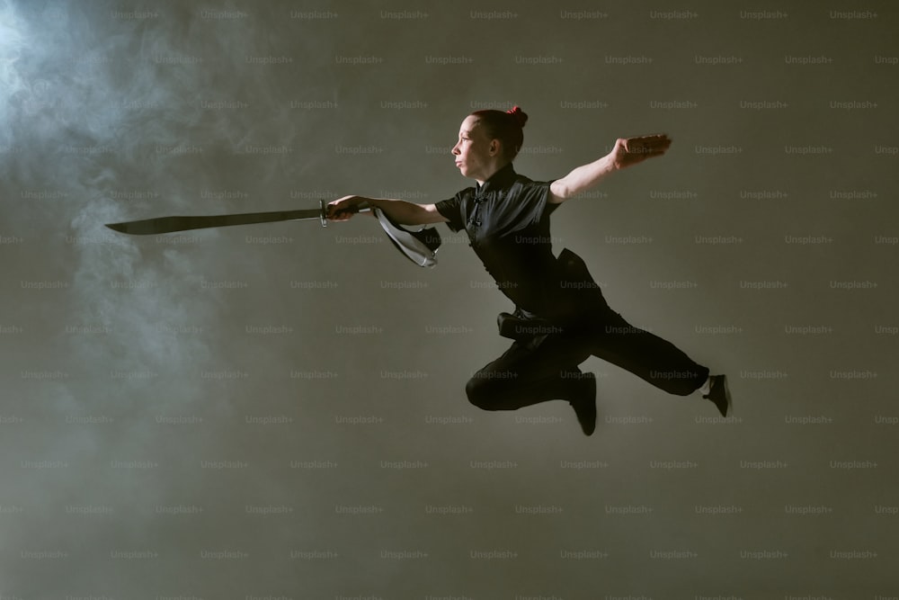 a woman flying through the air while holding a knife