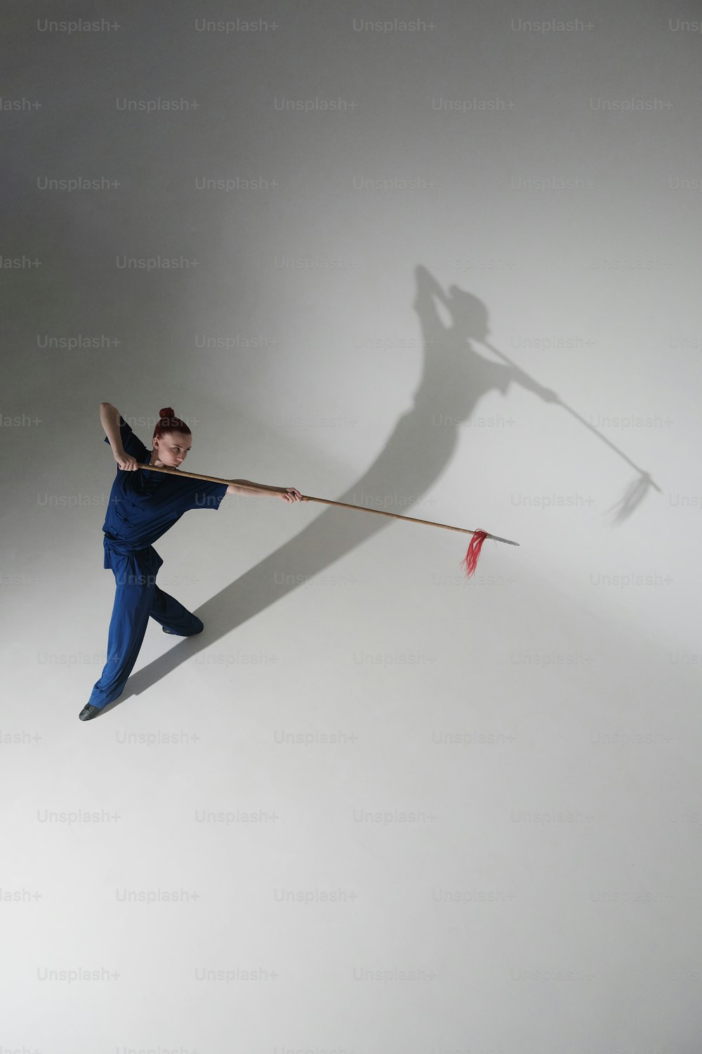 a woman holding a long stick in the air