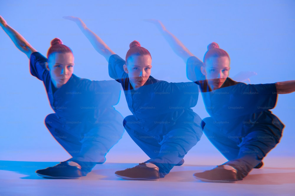 a group of three women in blue outfits