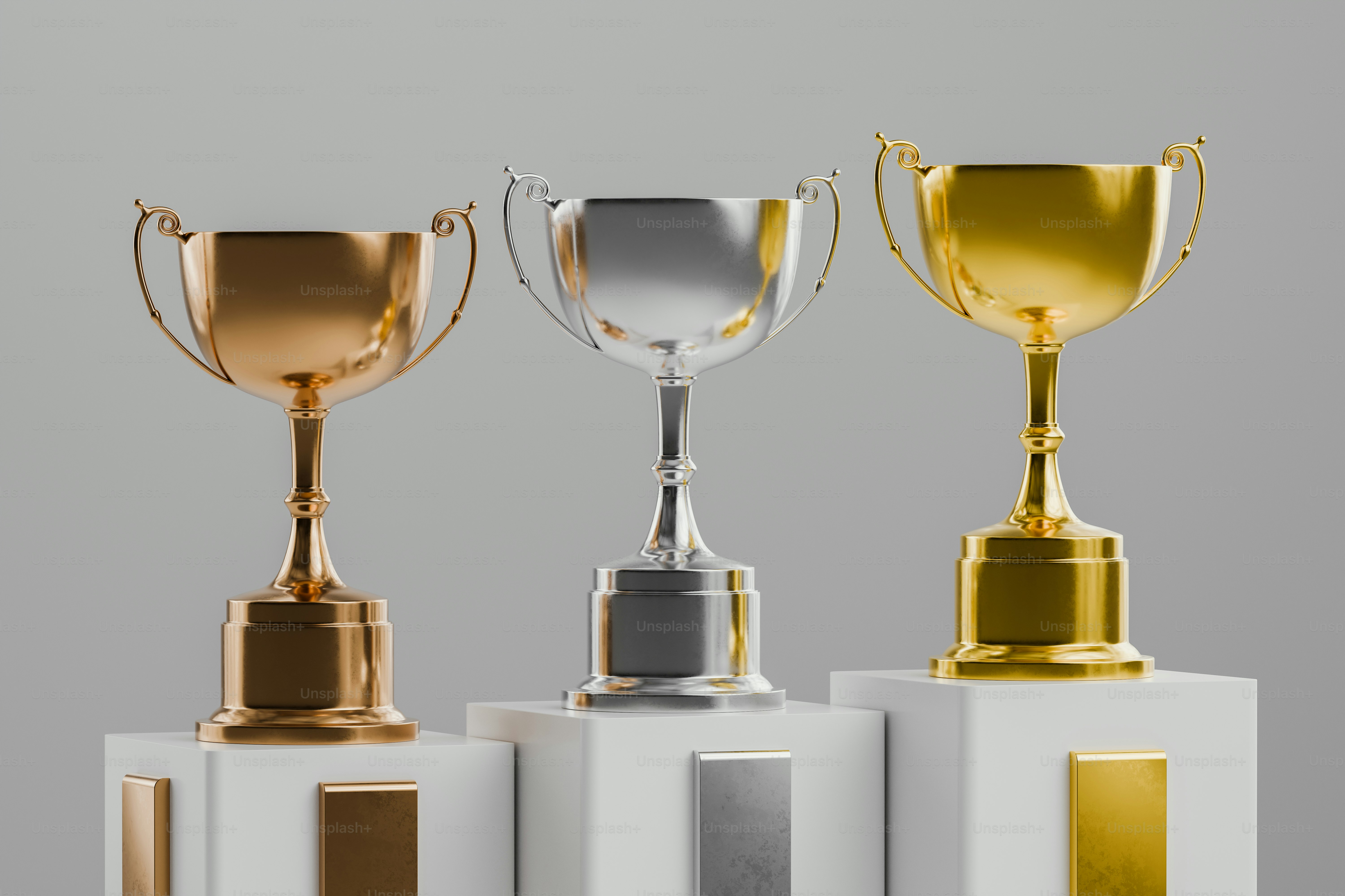 3D render of gold, silver, and bronze trophy cups.