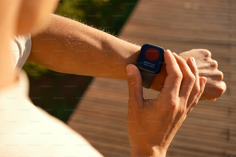 a person holding a smart watch in their hand