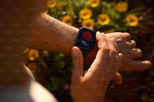 a close up of a person holding a smart watch