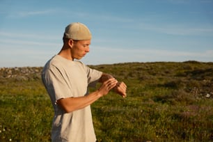 a man standing in a field holding a frisbee