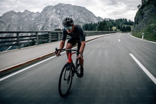 a man riding a bike down a curvy road