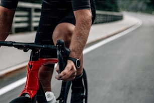 a close up of a person riding a bike on a road