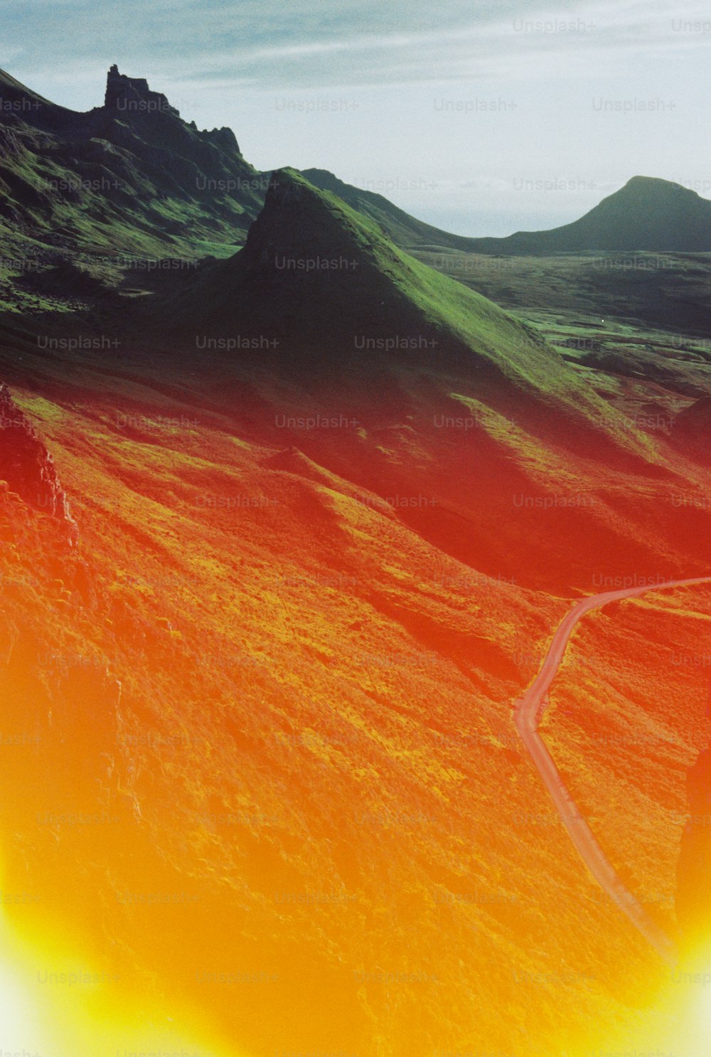 an aerial view of a winding road in the mountains