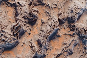 a close up of a dirt surface with rocks