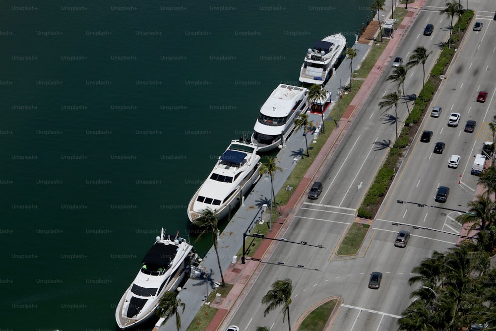 a couple of boats parked next to each other on the side of a road