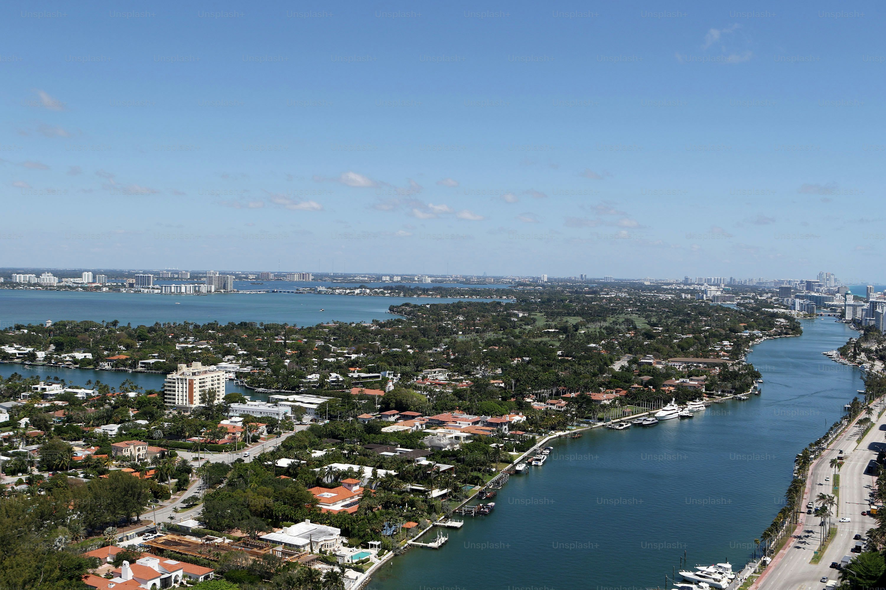 an aerial view of a city next to a body of water