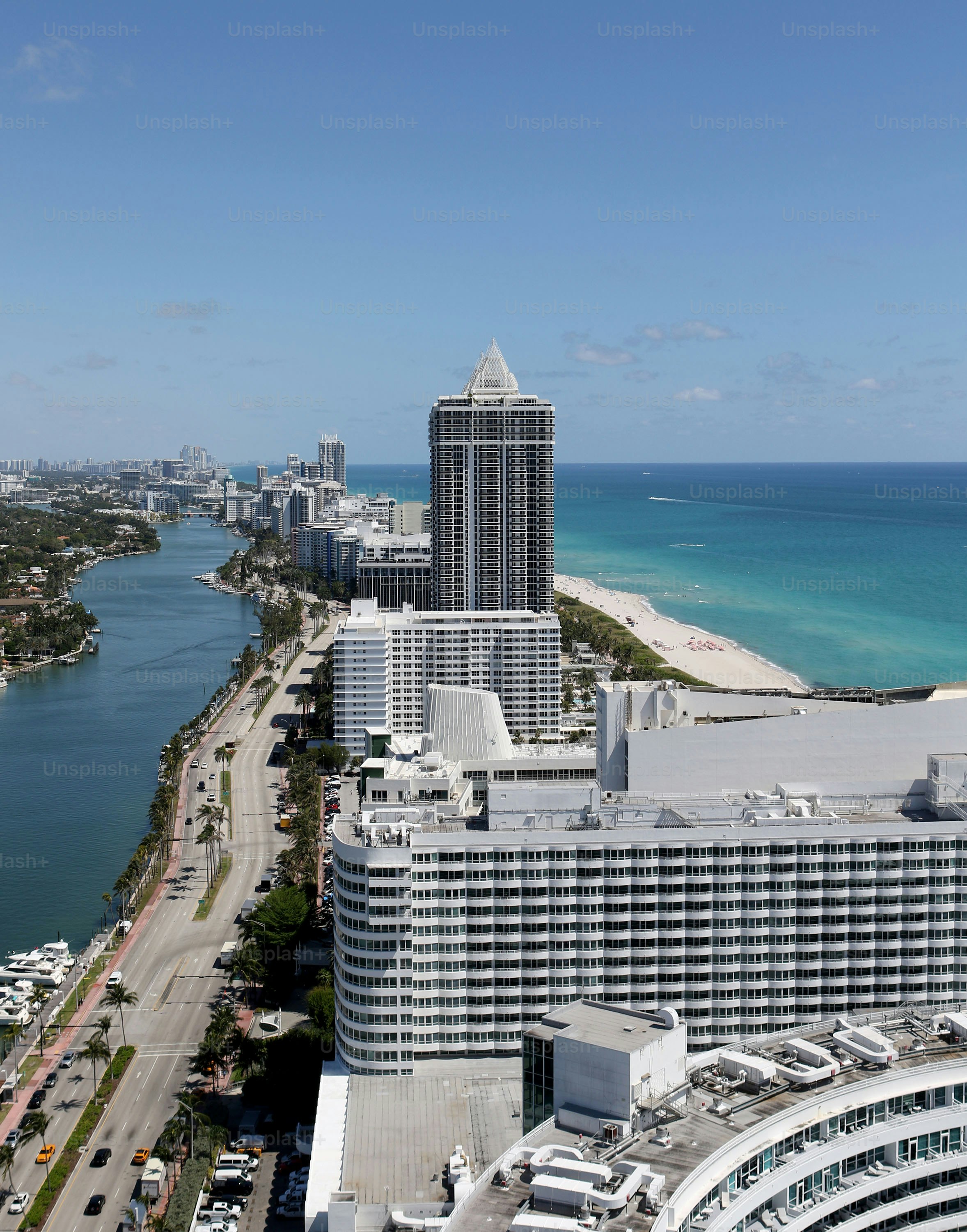 an aerial view of a city next to the ocean