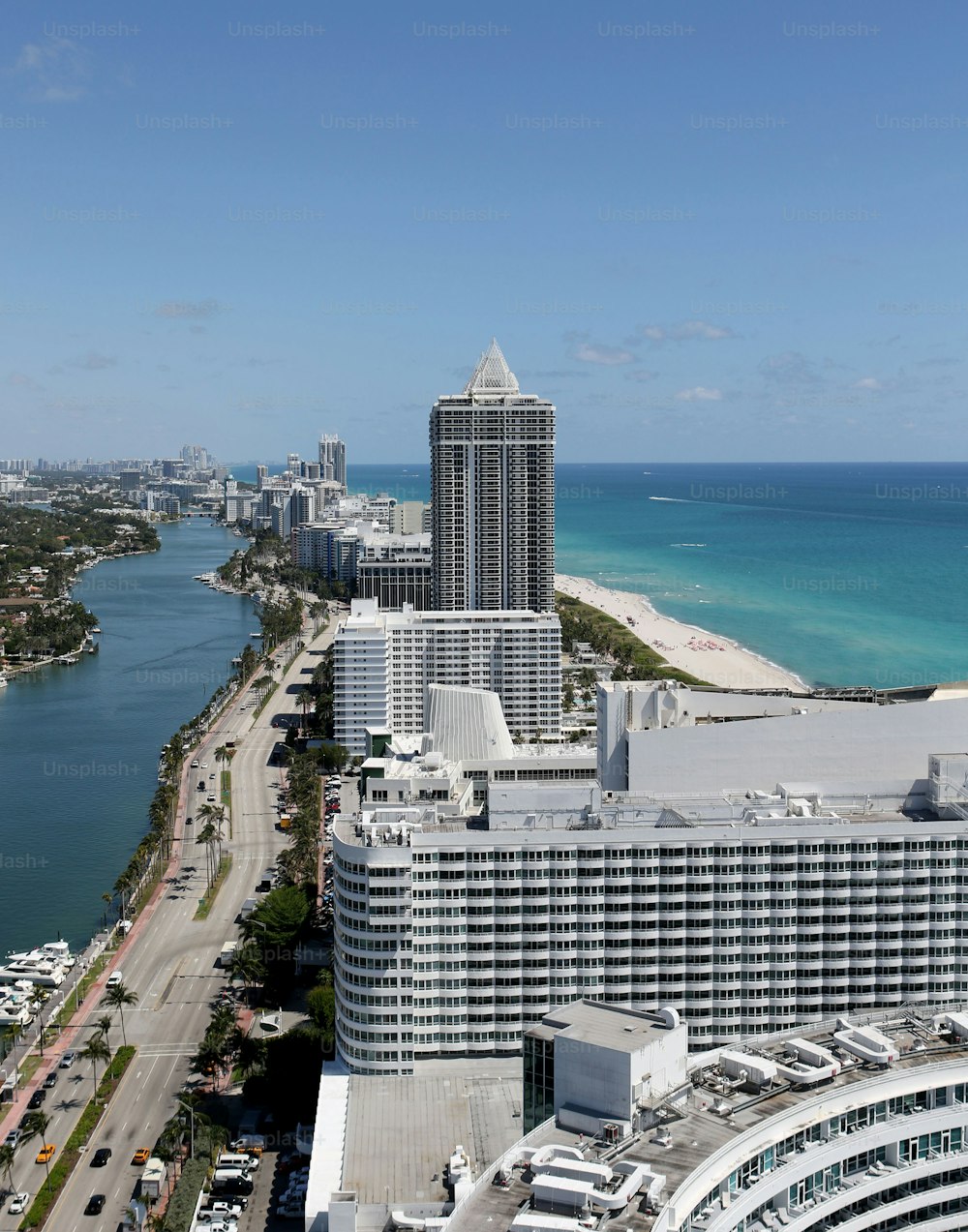 an aerial view of a city next to the ocean