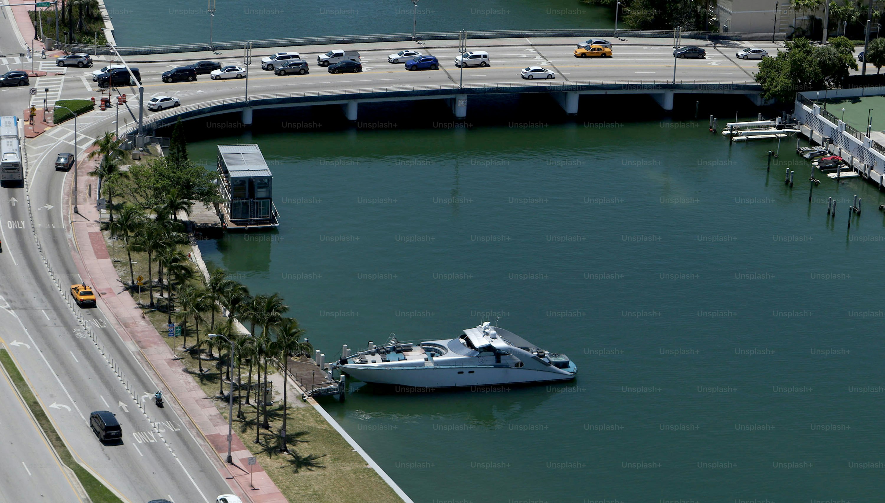 a boat in a body of water next to a bridge