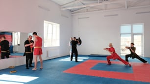 a group of people practicing martial in a room