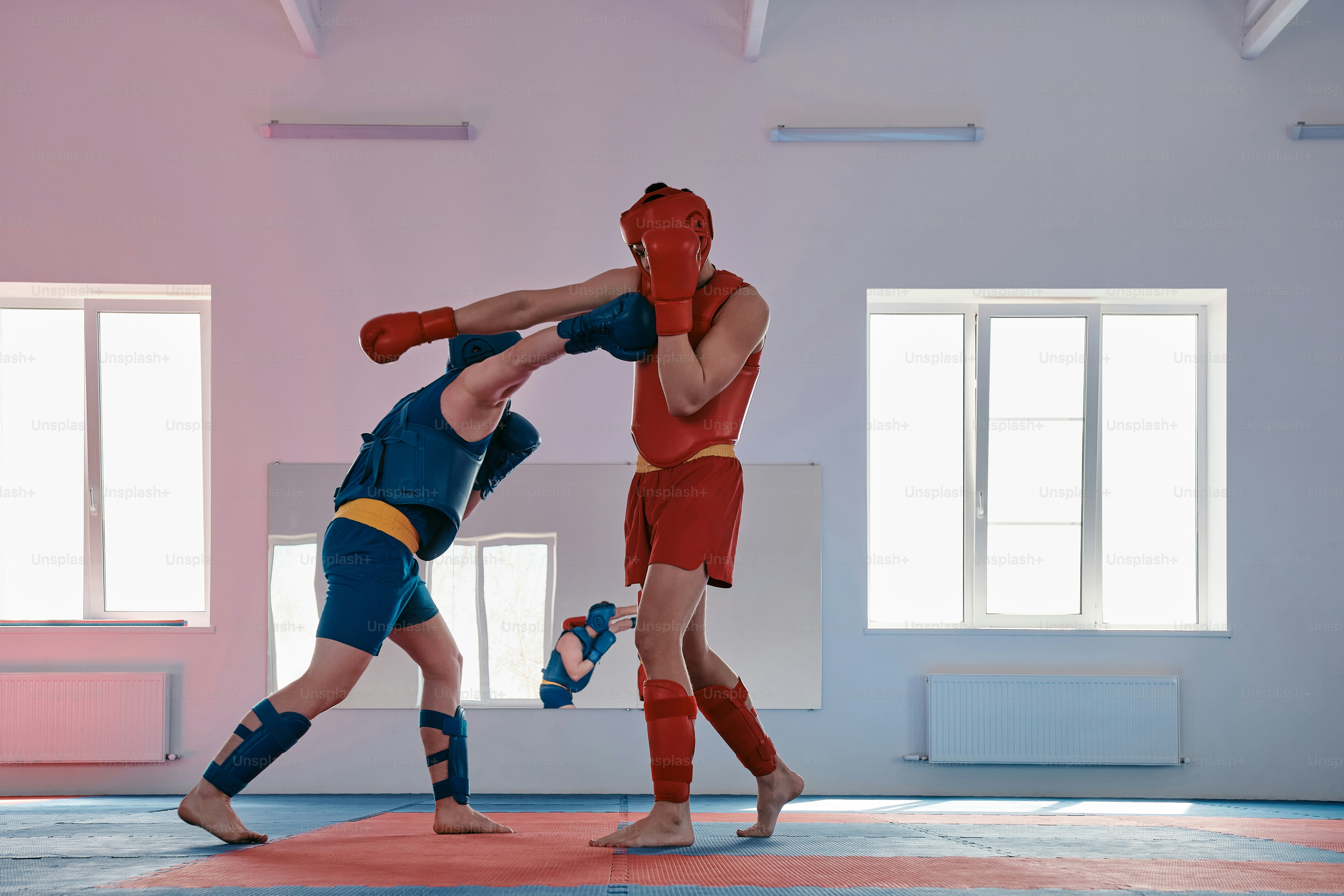 a couple of men standing on top of a wrestling ring
