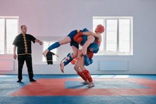 a man is doing a handstand on another man