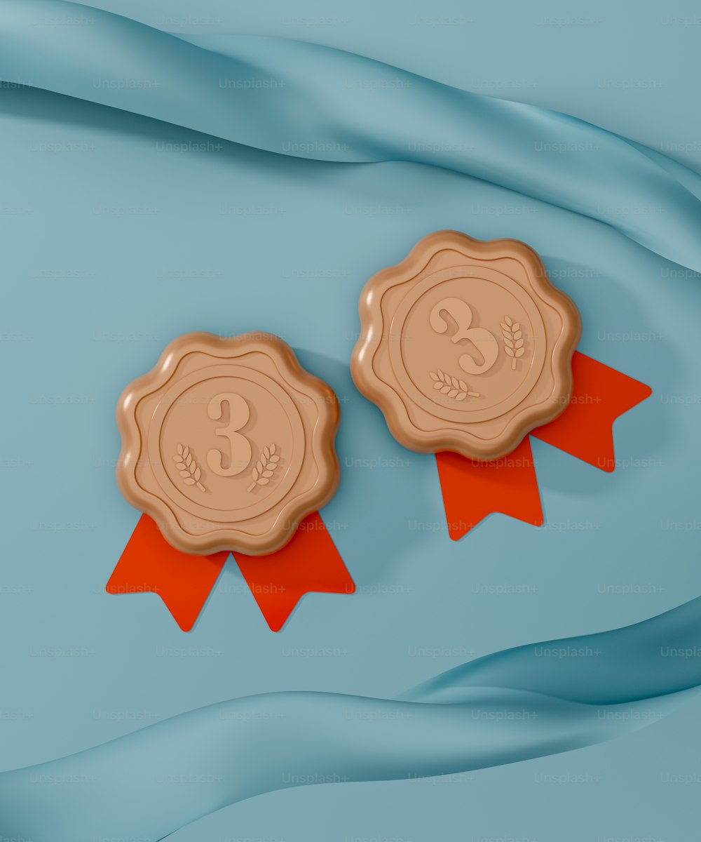 two wax seals with ribbons on a blue background
