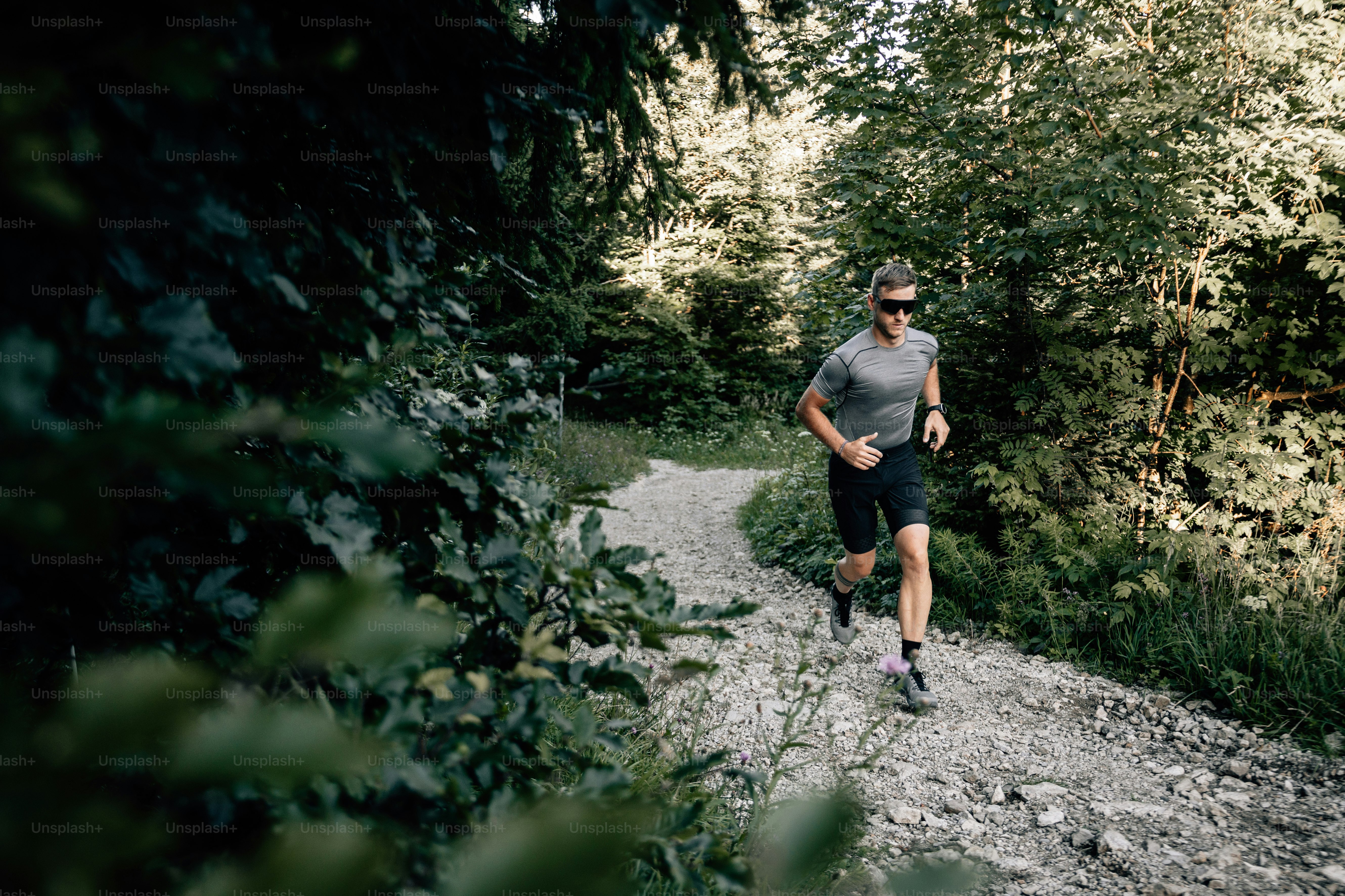a man running on a trail in the woods
