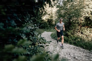 a man running on a trail in the woods