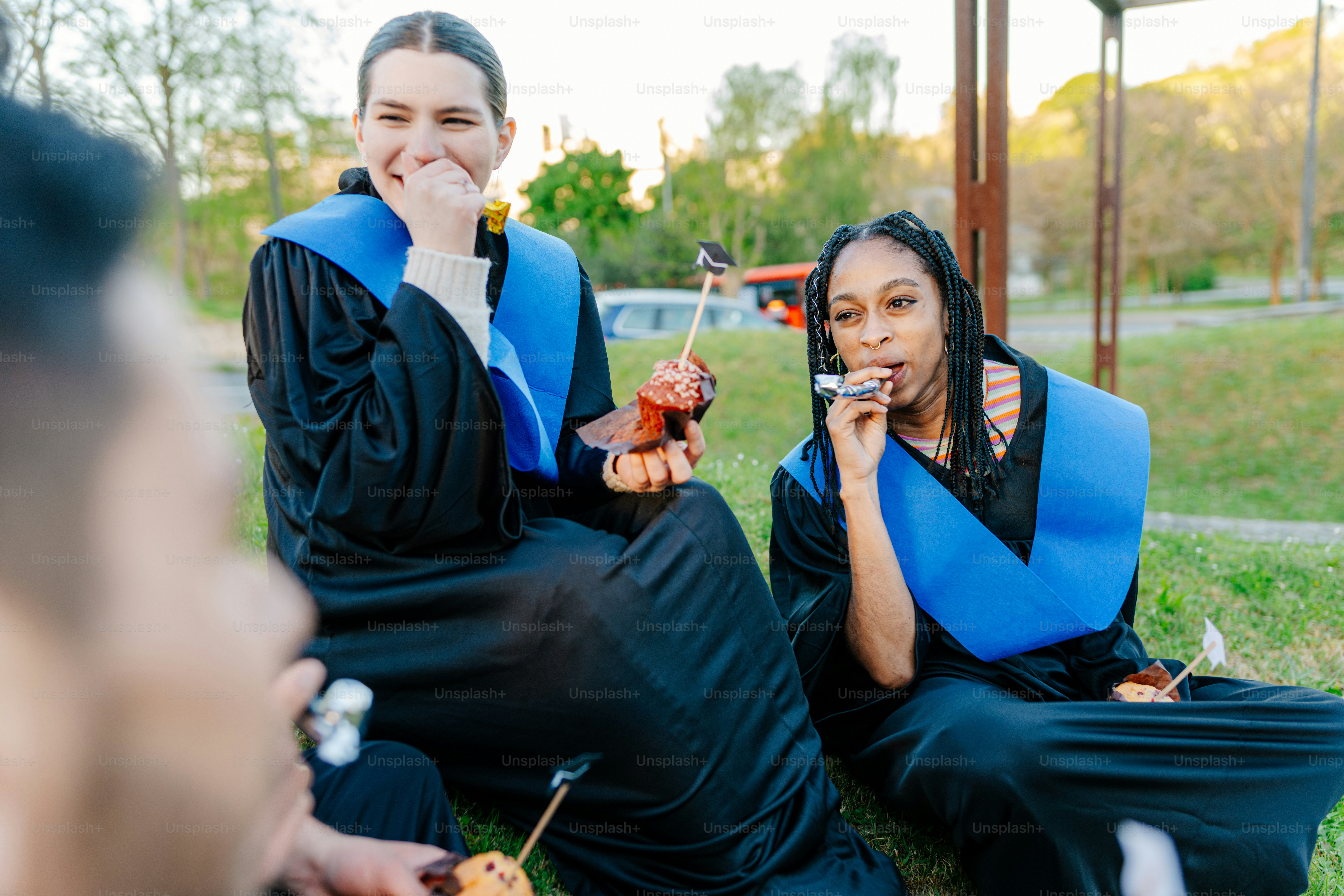 Graduates in caps and gowns pose for a selfie. photo – Education Image ...