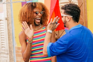 a man standing next to a woman in a colorful dress