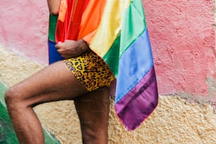 a man with a rainbow shirt and leopard print shorts