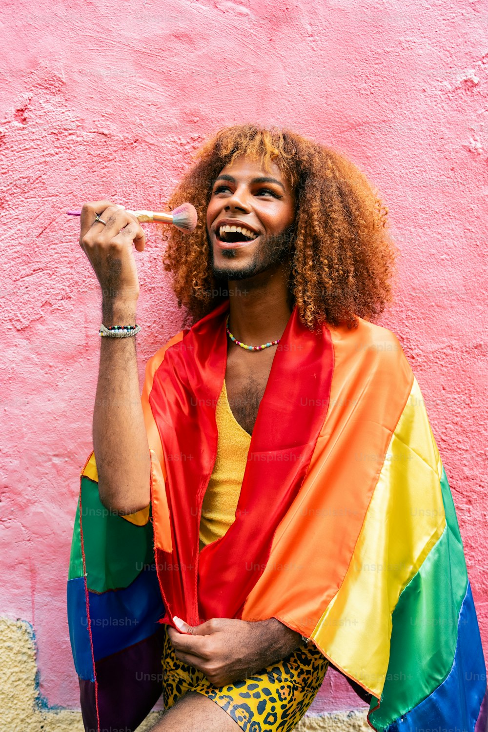 a man with long hair and a rainbow shirt