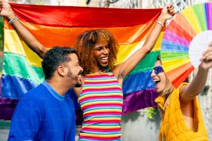 a group of people holding a rainbow flag