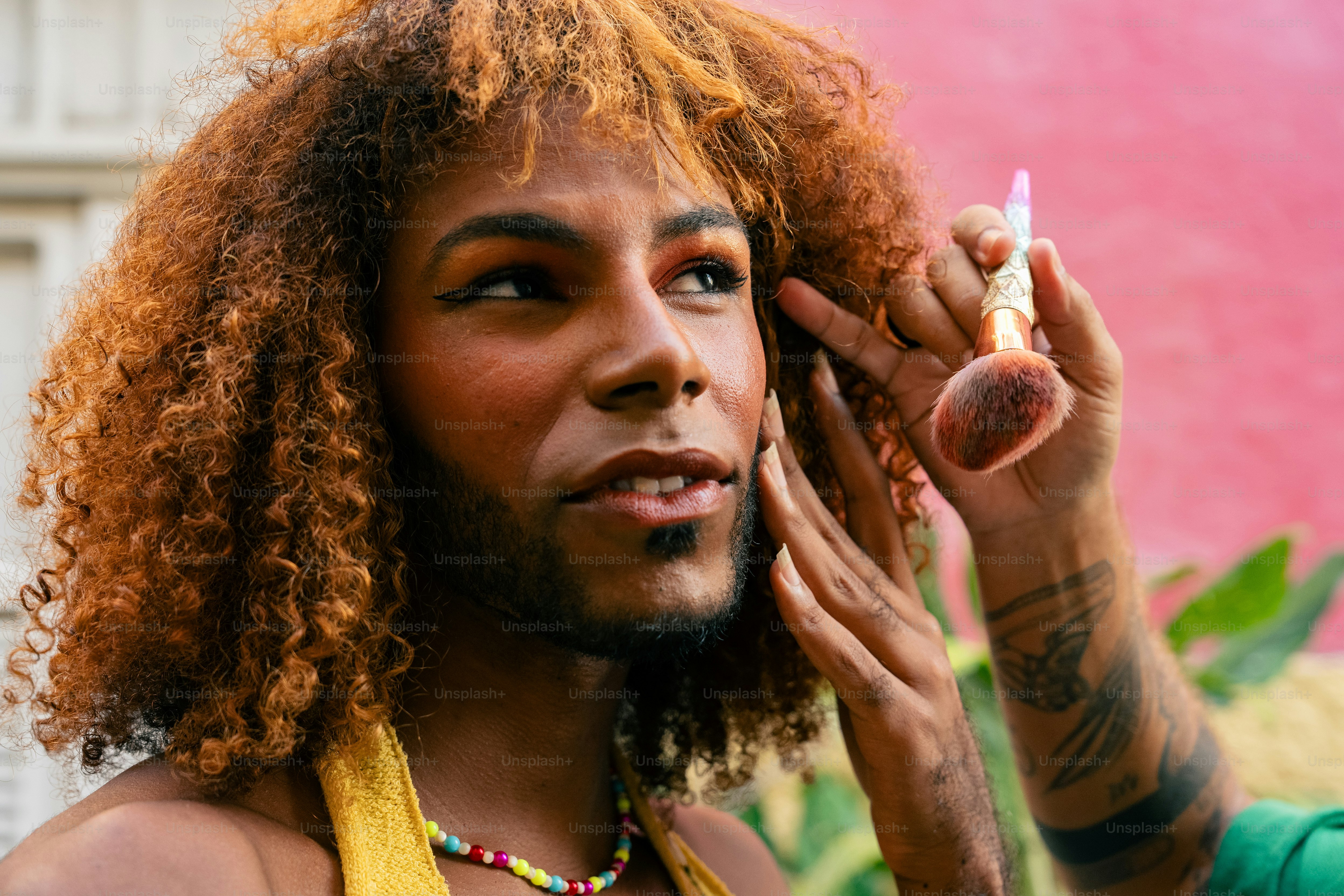 a man with red hair is smoking a cigarette