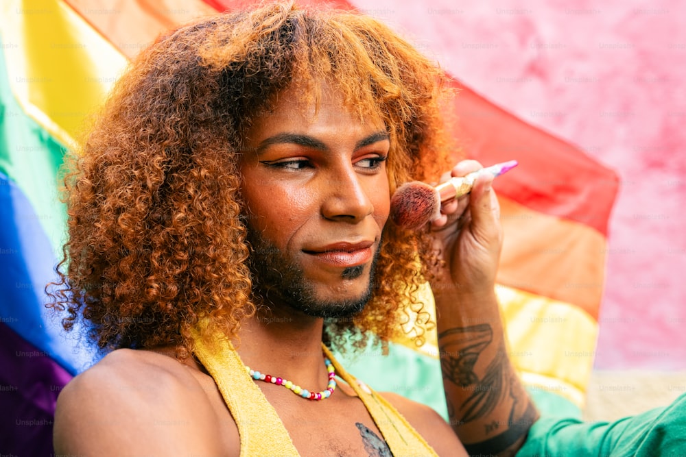 a man with long curly hair holding a cigarette