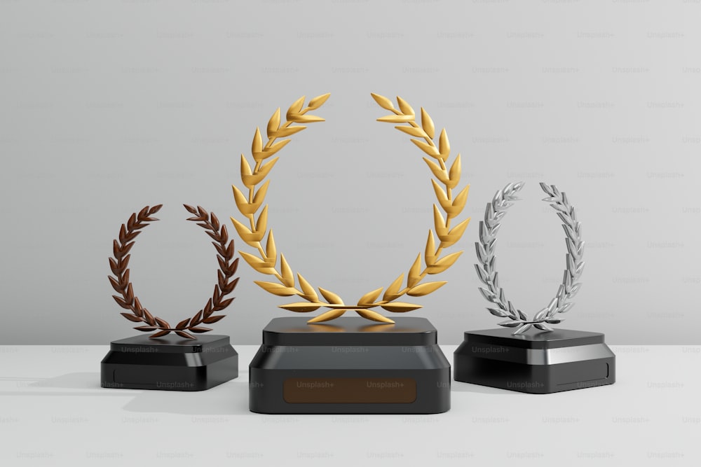 three trophies with gold, silver, and bronze decorations