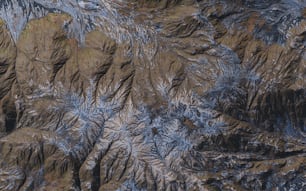 an aerial view of a mountain range covered in ice