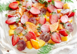a white plate topped with fruit covered in powdered sugar