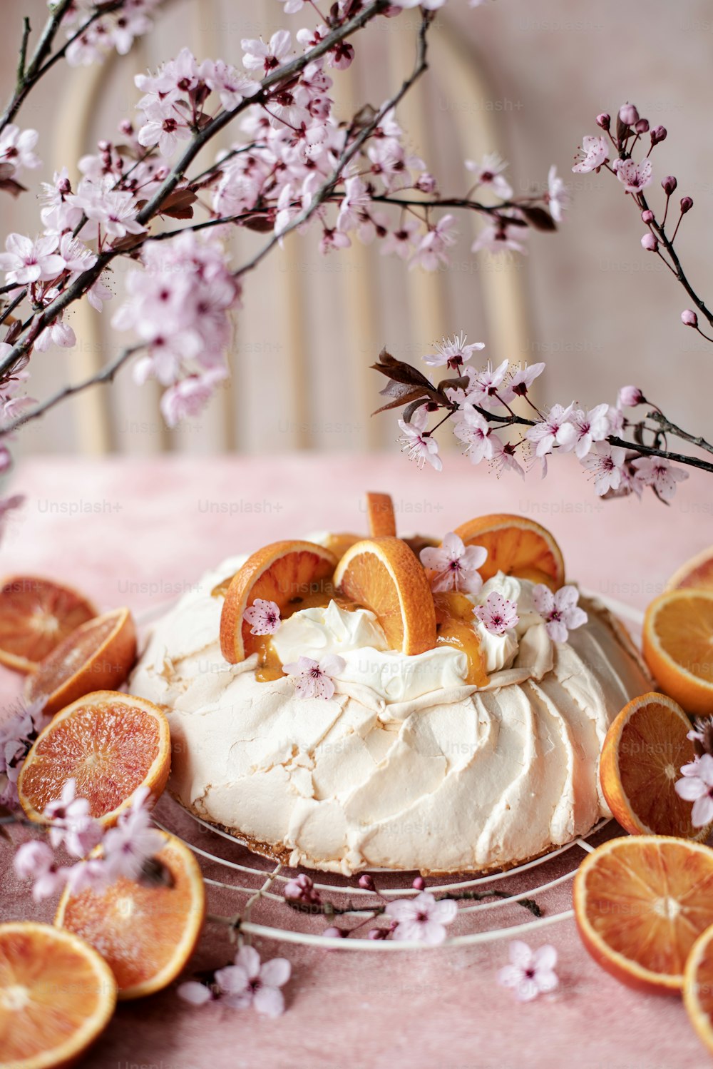 a cake sitting on top of a table covered in orange slices