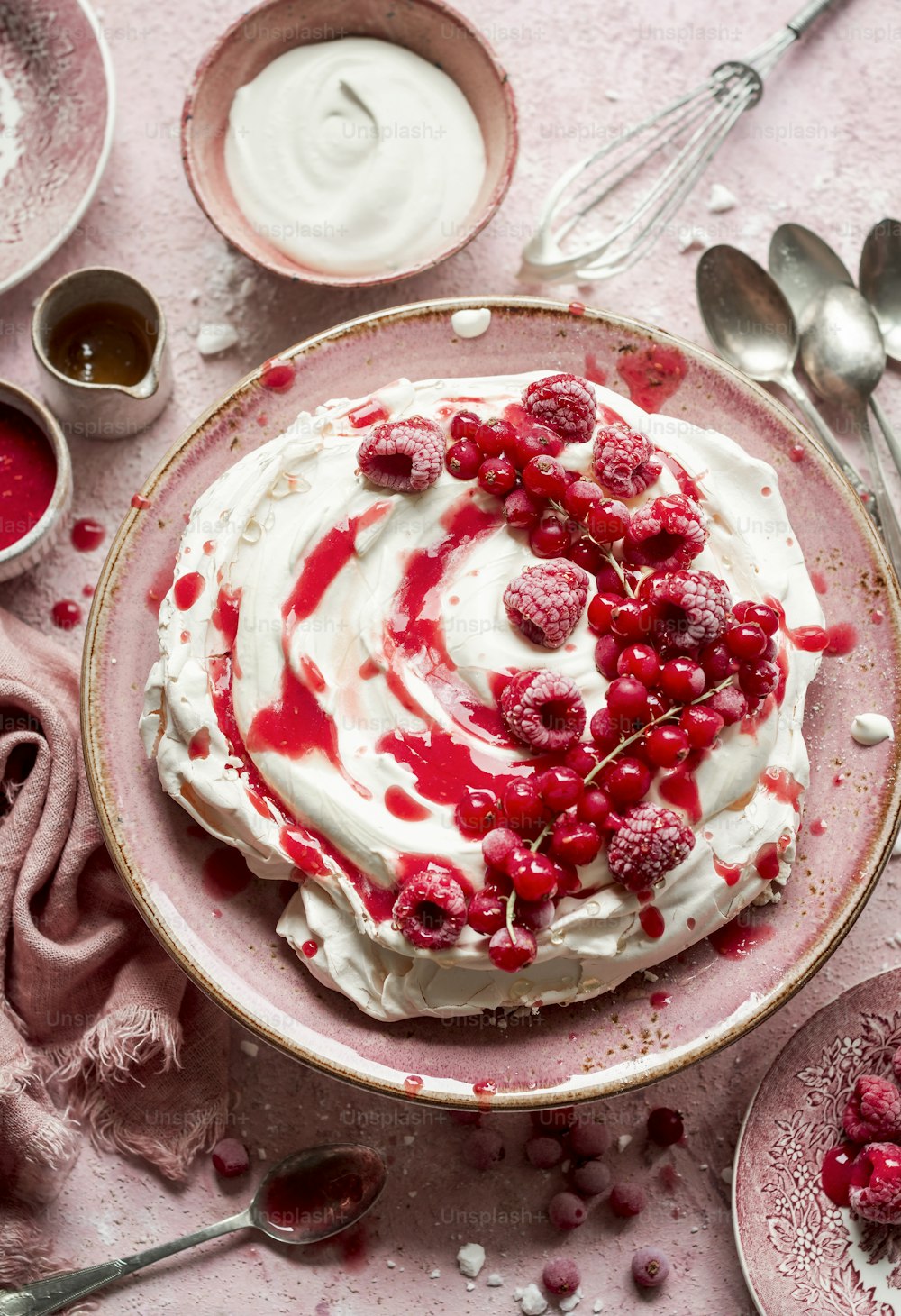 a bowl of whipped cream with raspberries on top