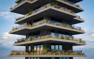 a tall building with balconies and flowers on the balconies