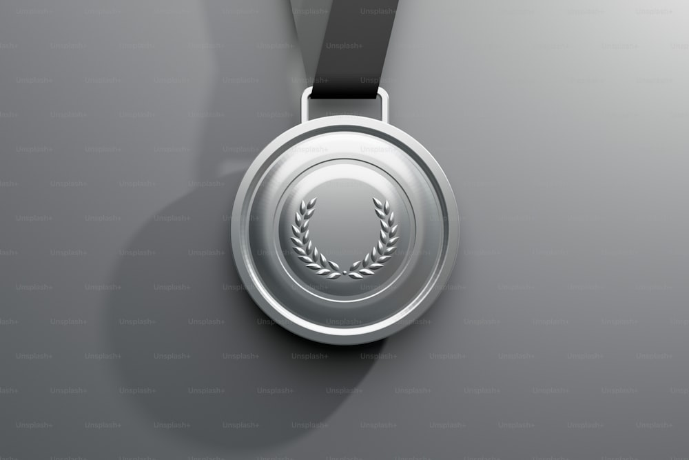 a silver medal with a black ribbon around it