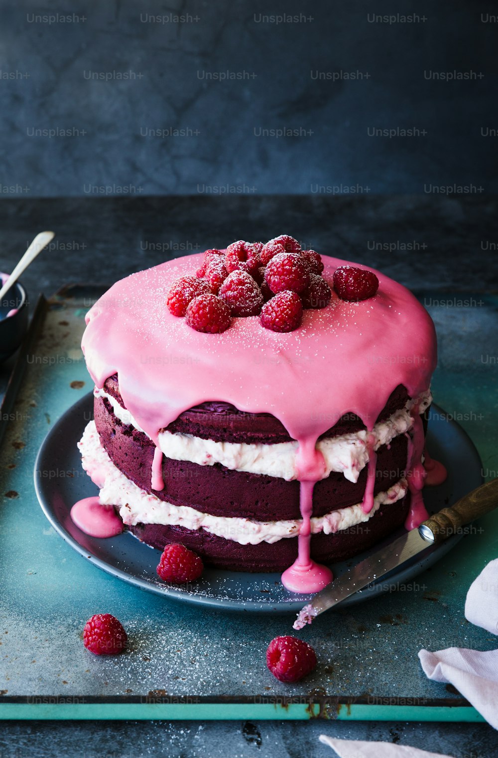 a cake with raspberries on top of it