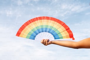 a person holding a colorful fan in their hand