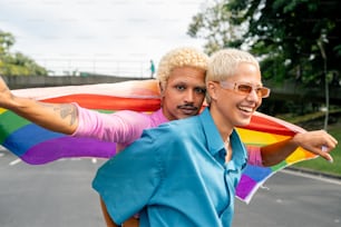 a man and a woman holding a rainbow flag