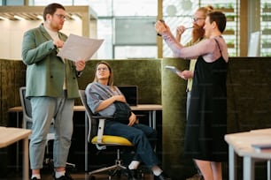 a group of people standing around a woman in a chair